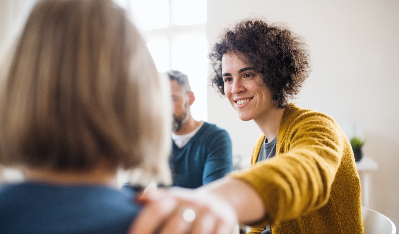 Smiling woman listening during a group session