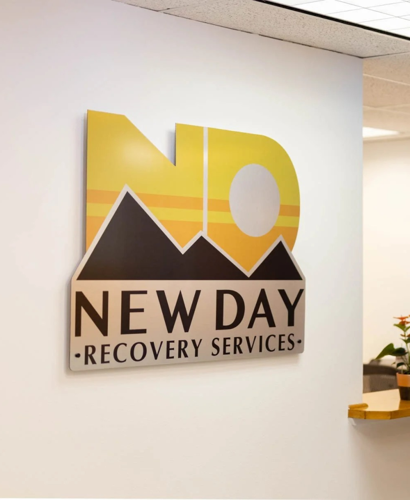 New Day Recovery Services logo sign on an office wall