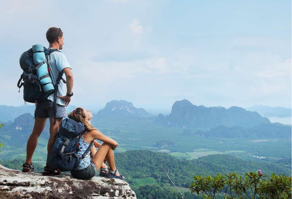 Hikers with backpacks looking over a mountain valley
