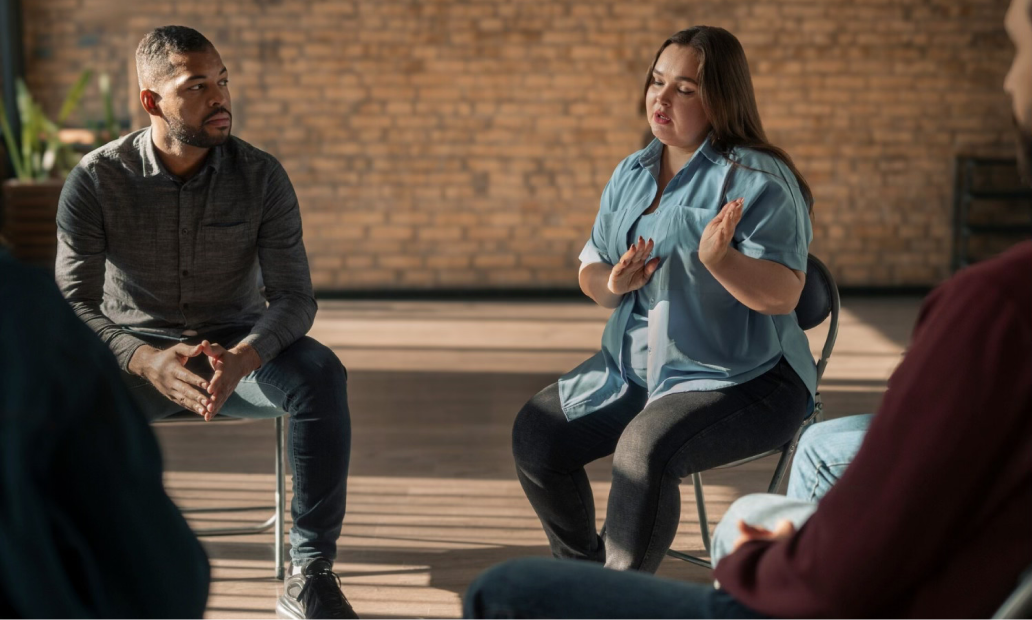 Counselor speaking to members of a group therapy session