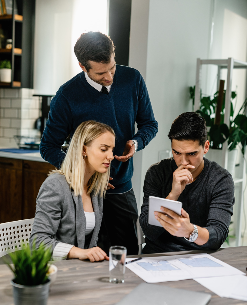 Advisor reviewing documents with a couple at a table