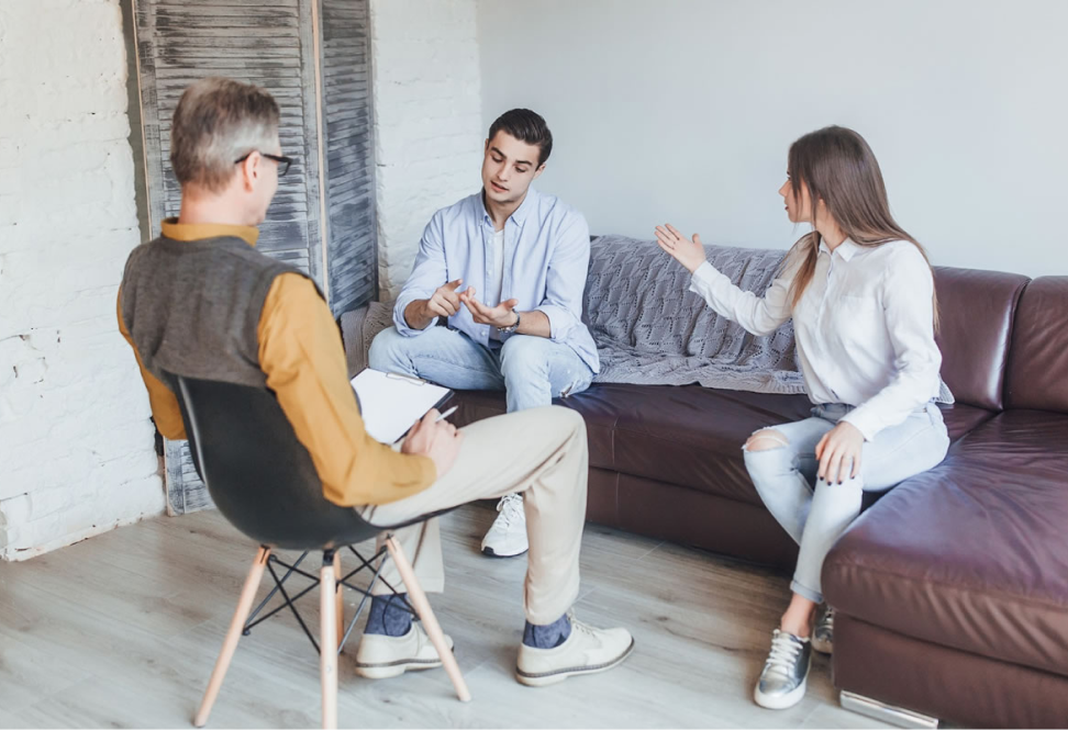 Therapist meeting with a young couple on a couch