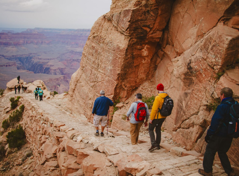 Hikers walking a canyon trail