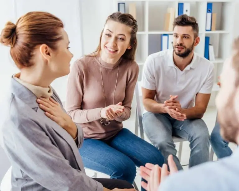 Group members talking and smiling during a session
