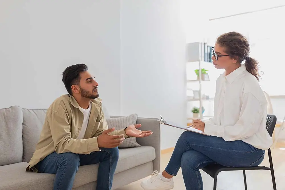 Man gesturing while talking with his therapist