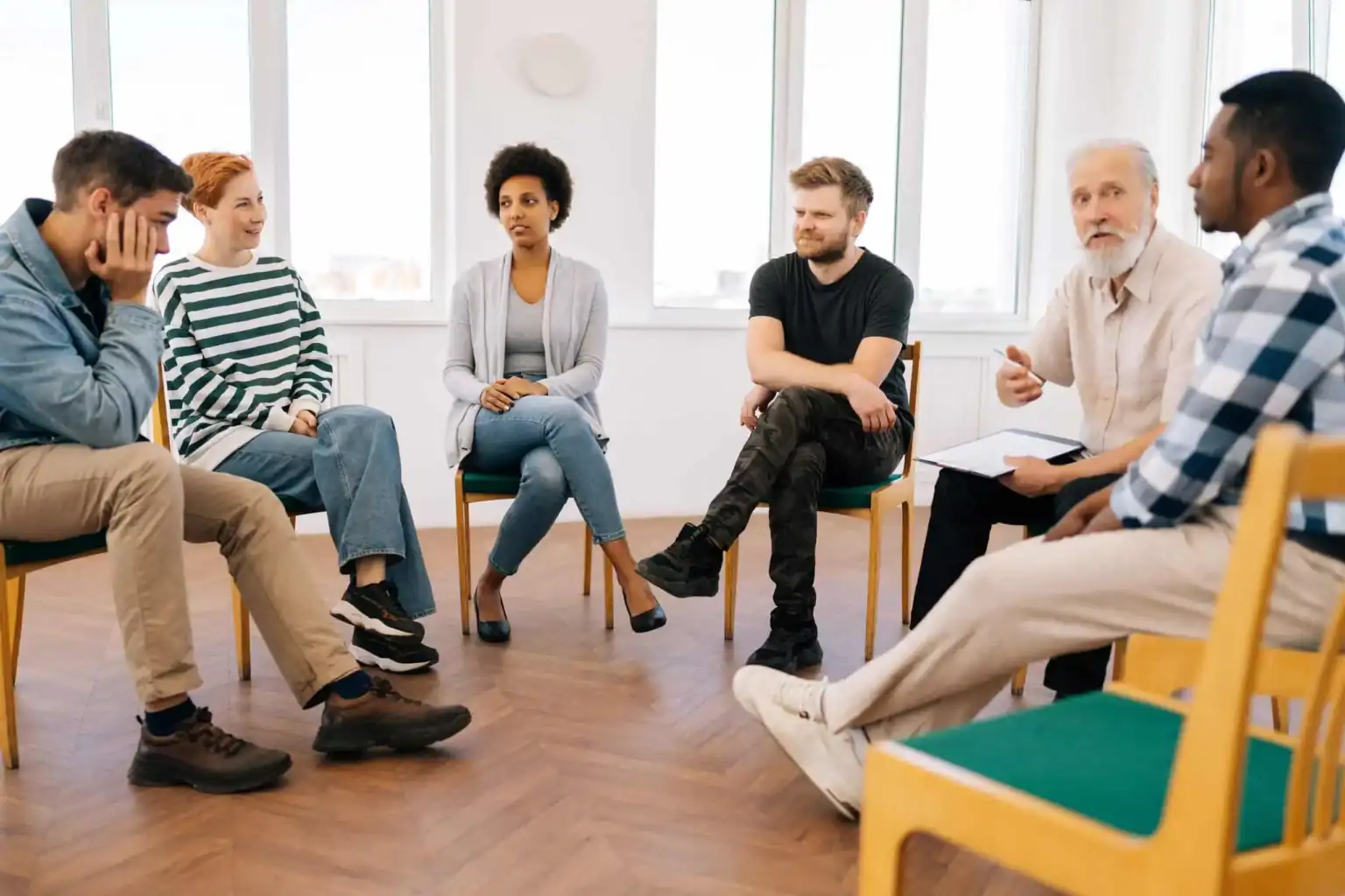 Group therapy circle in serious discussion