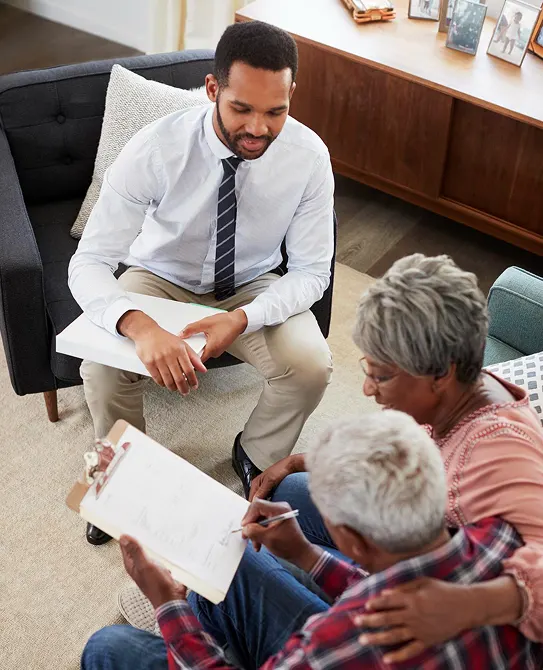 Clinician reviewing paperwork with an older couple