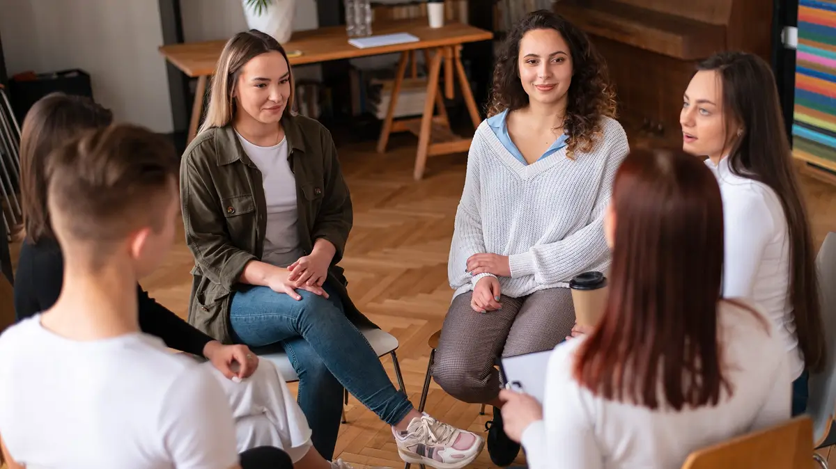 Young women talking in a group therapy circle