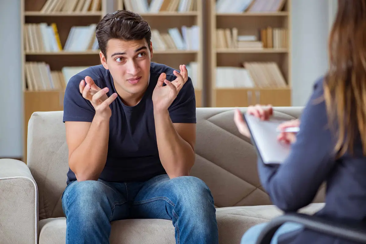 Man gesturing while talking with a therapist