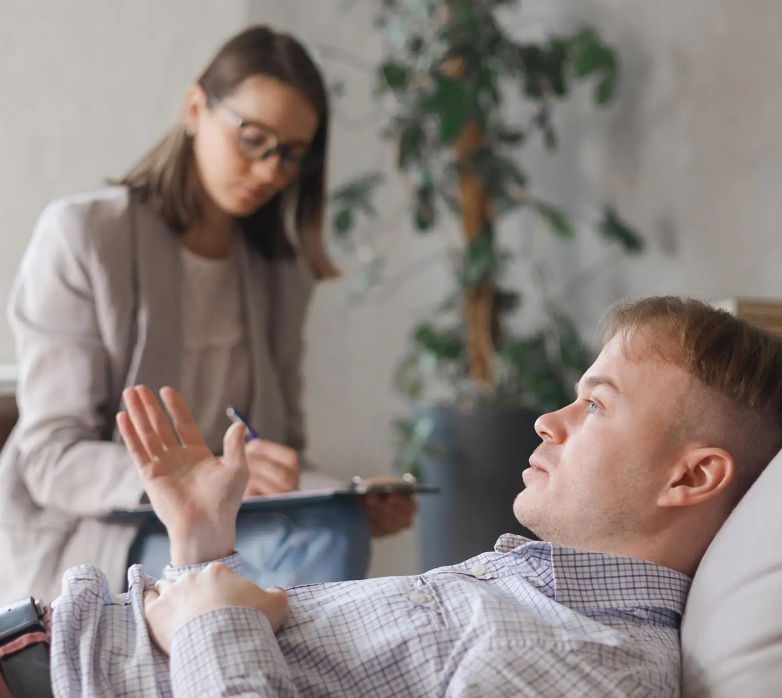 Counselor talking with a man resting in a chair