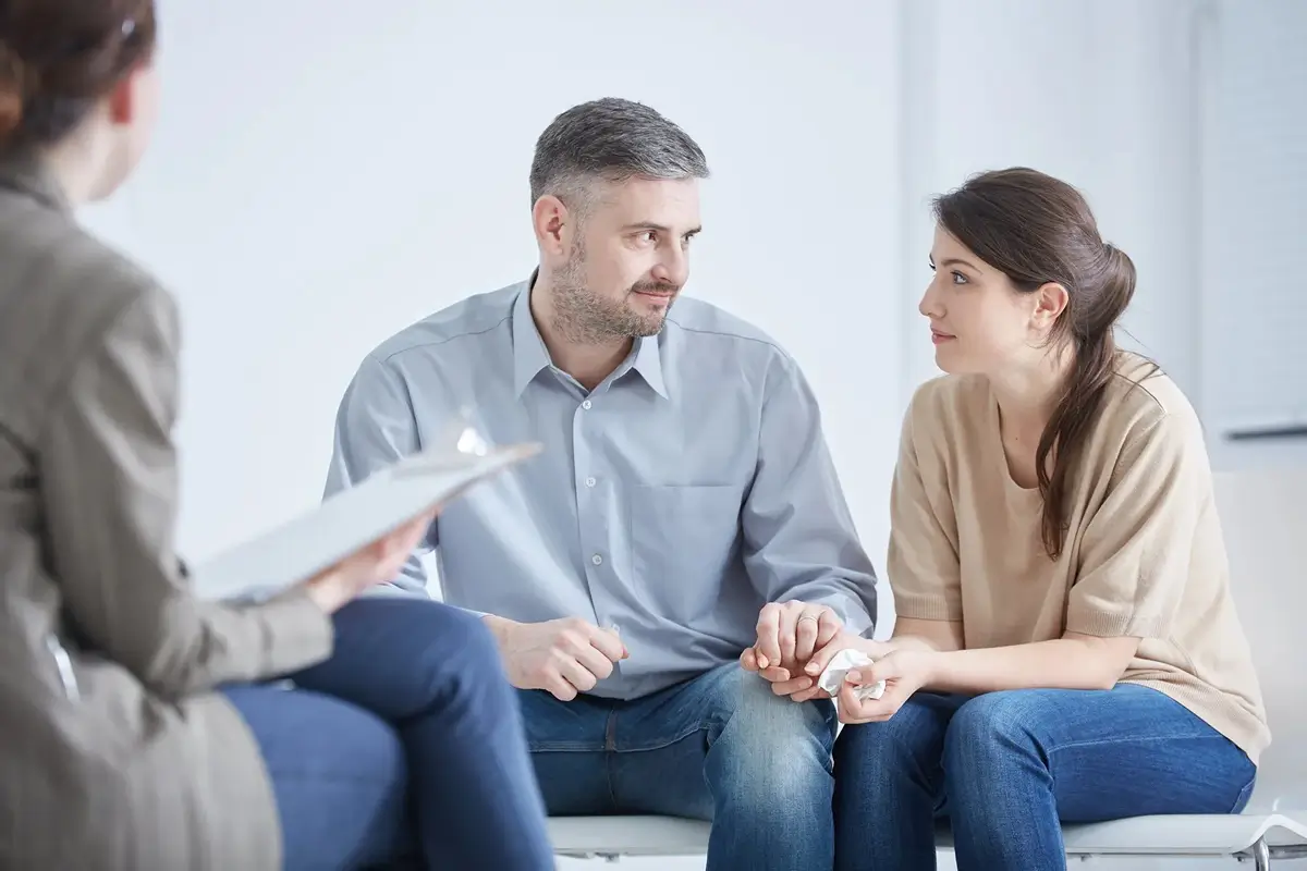 Couple reviewing documents with a counselor