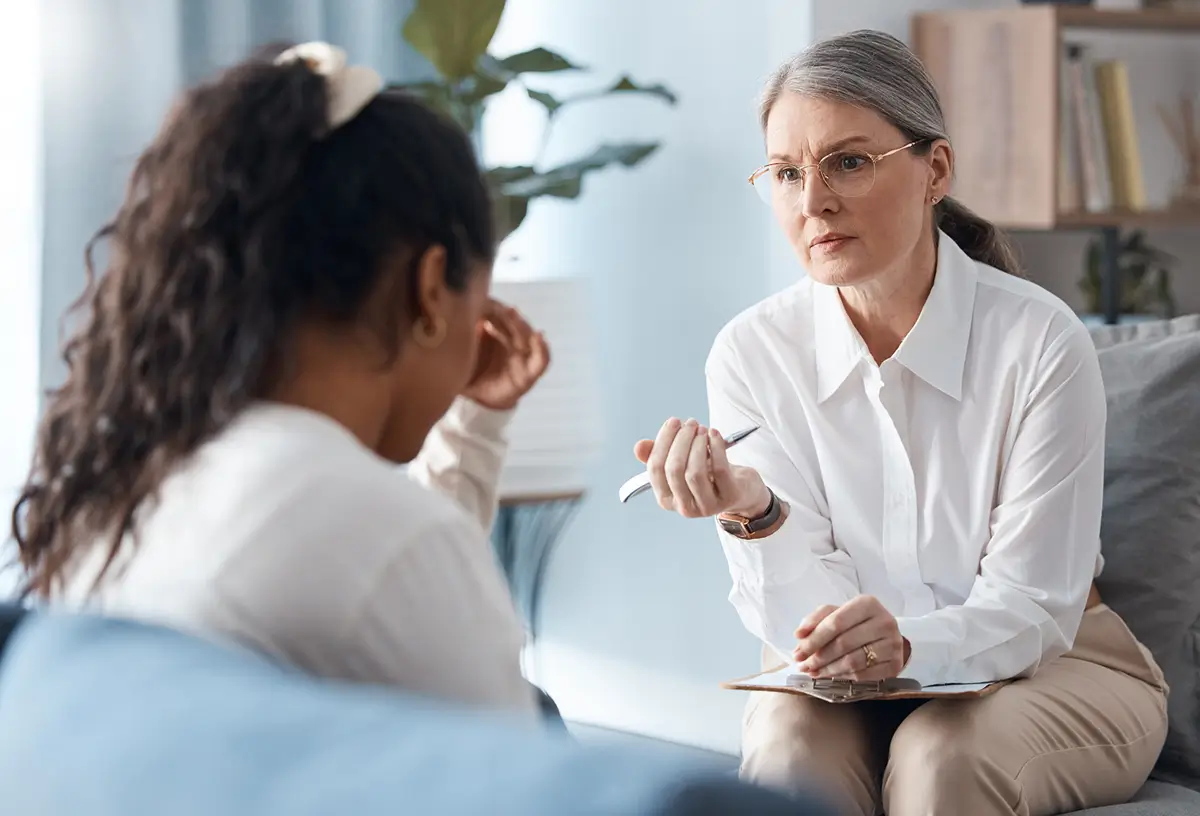 Counselor talking with a young woman in session