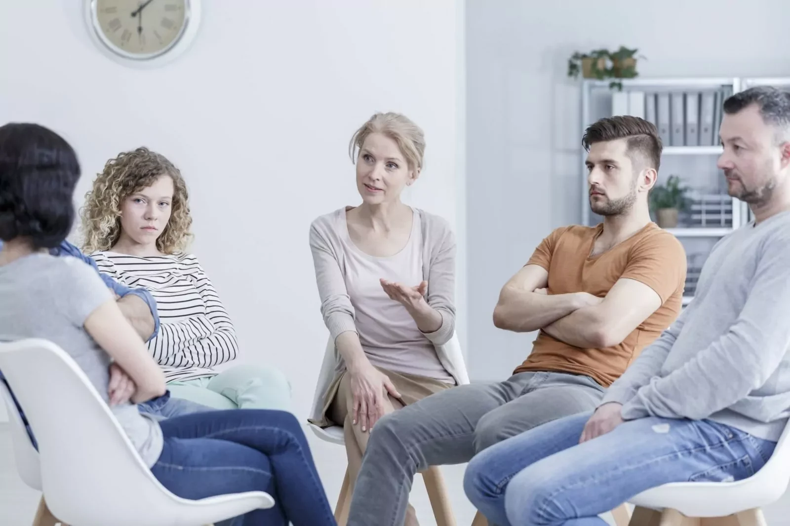 Support group seated in a circle listening to a member