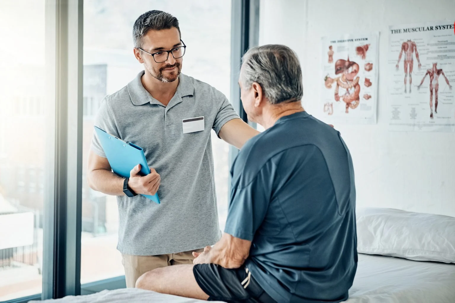 Clinician talking with an older patient in an exam room