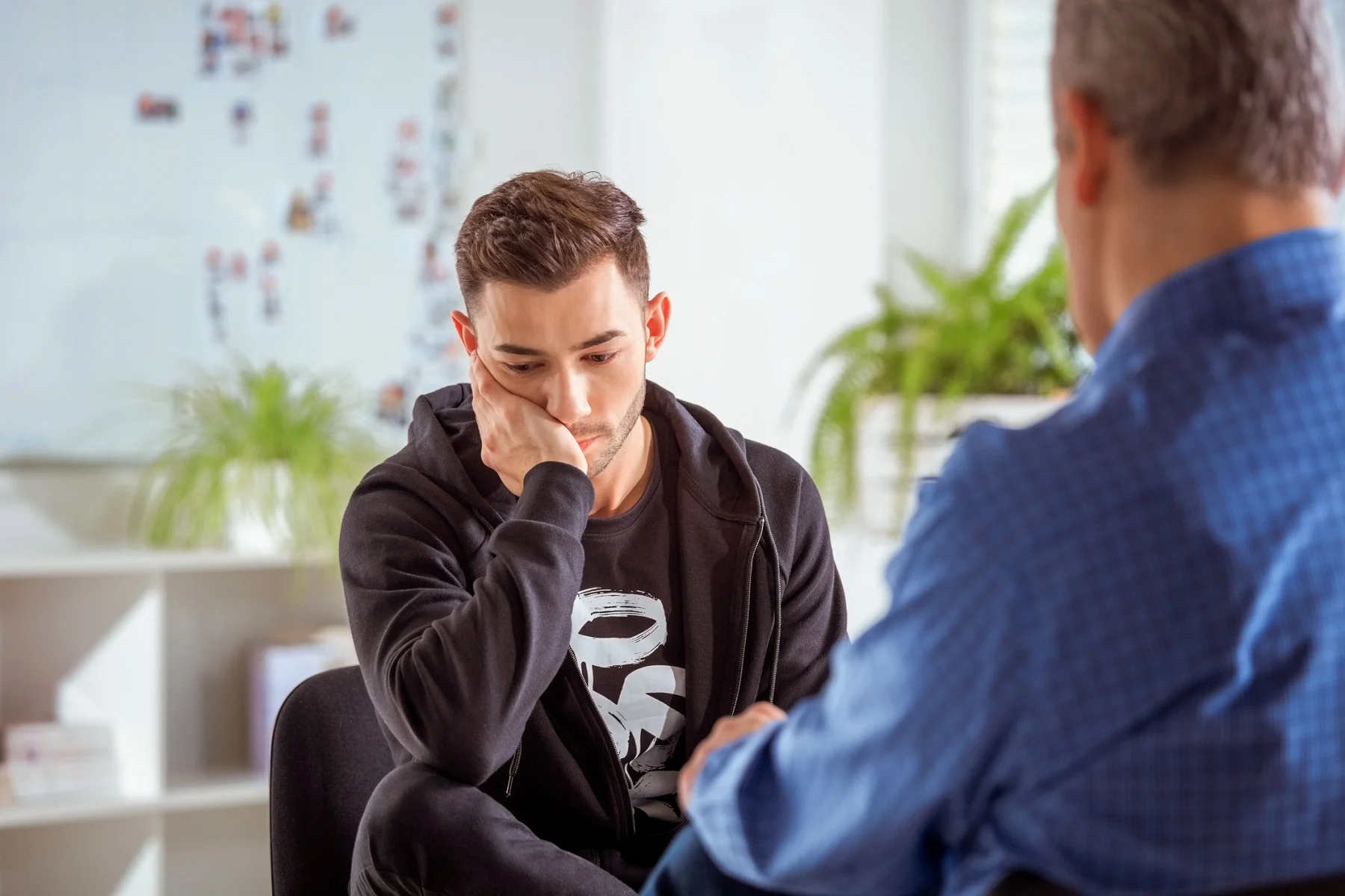 Young man listening during a one-on-one counseling session
