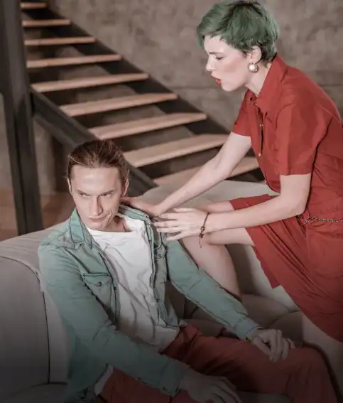 Woman checking on a man slumped in a chair