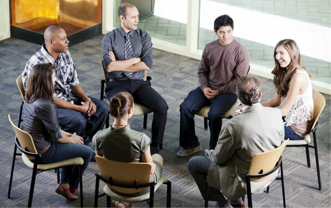 Large group therapy circle in an open room