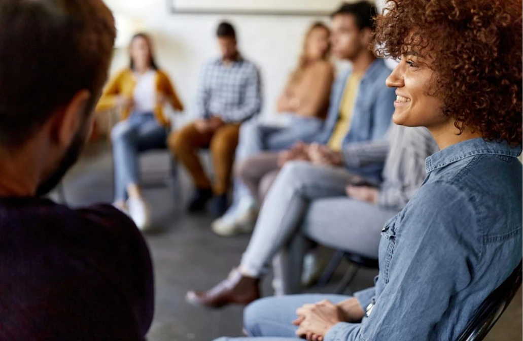 Smiling woman participating in a group therapy session