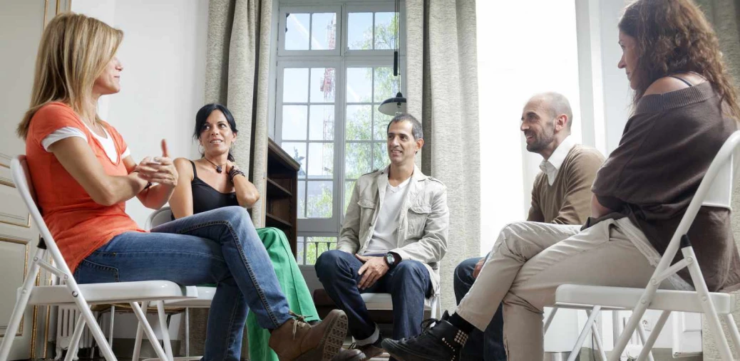 Support group members talking in a seated circle