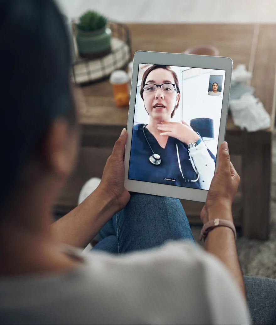 Woman on a tablet video call with a doctor