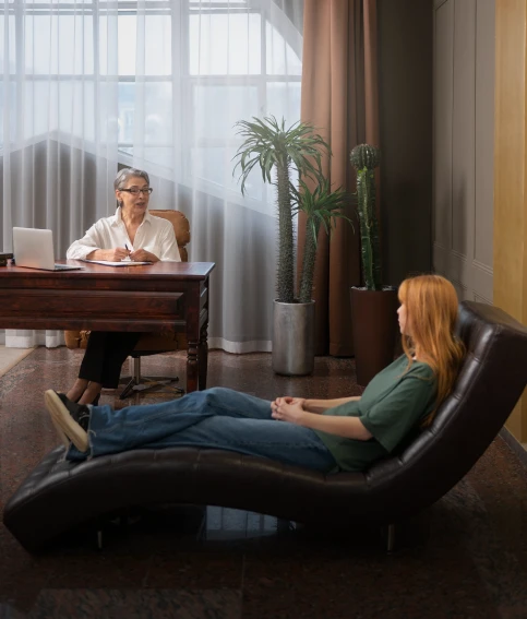 Client reclining on a chaise during a therapy session