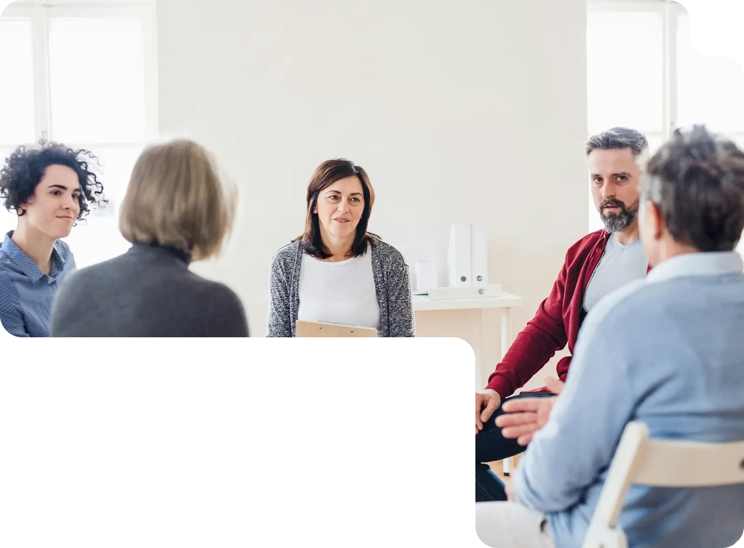 Adults talking in a group therapy circle