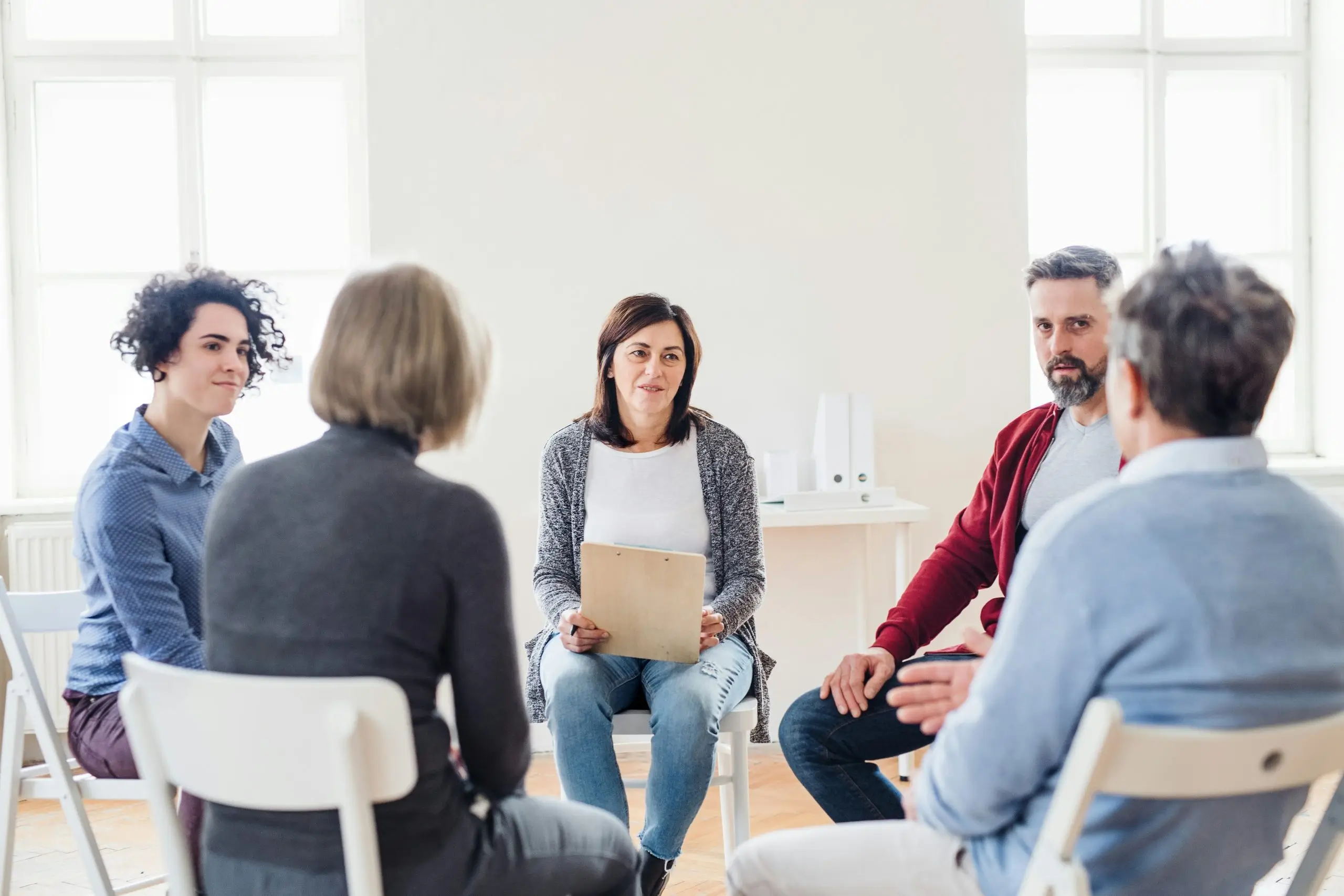 Group therapy session seated in a circle
