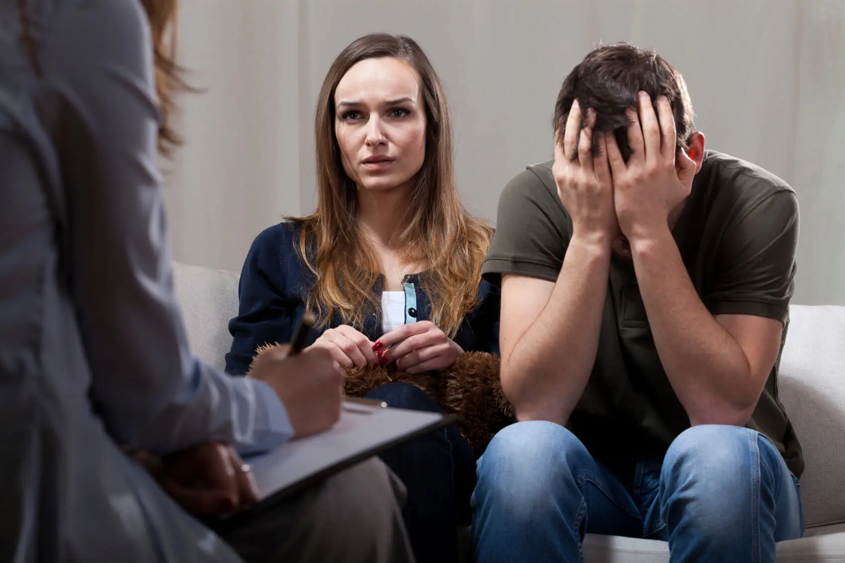 Distressed couple talking with a counselor