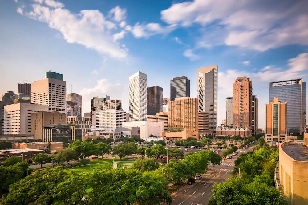 Houston skyline above a tree-lined park