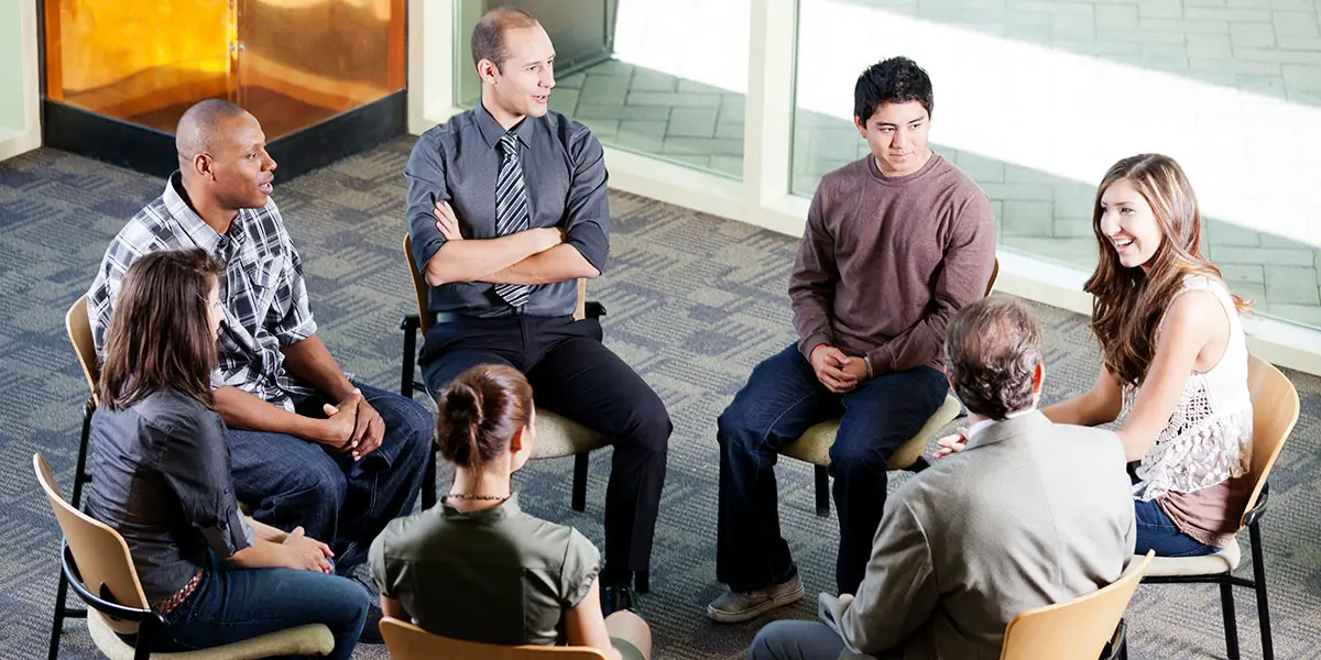 Group session in a lounge with members seated in a circle