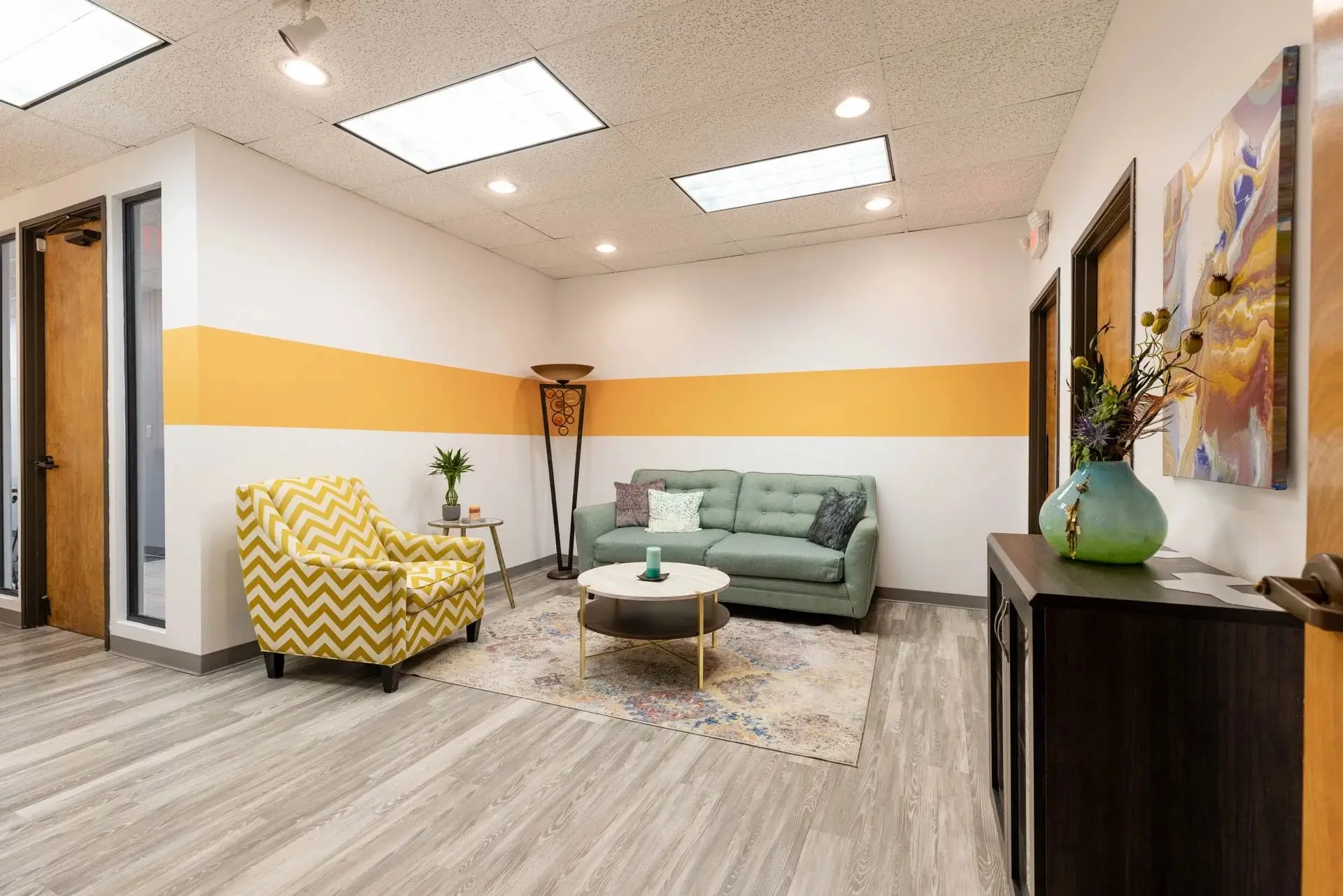 Lounge area with couches and chairs inside a sober living home