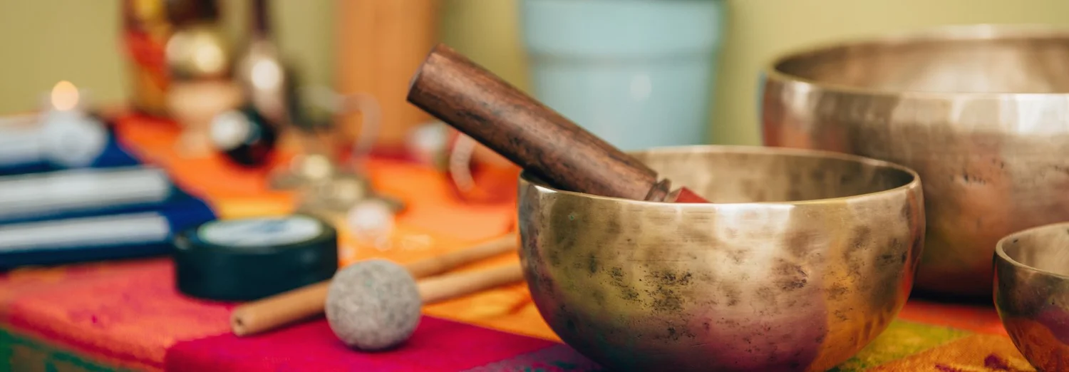 Singing bowls and instruments set up for a sound bath session