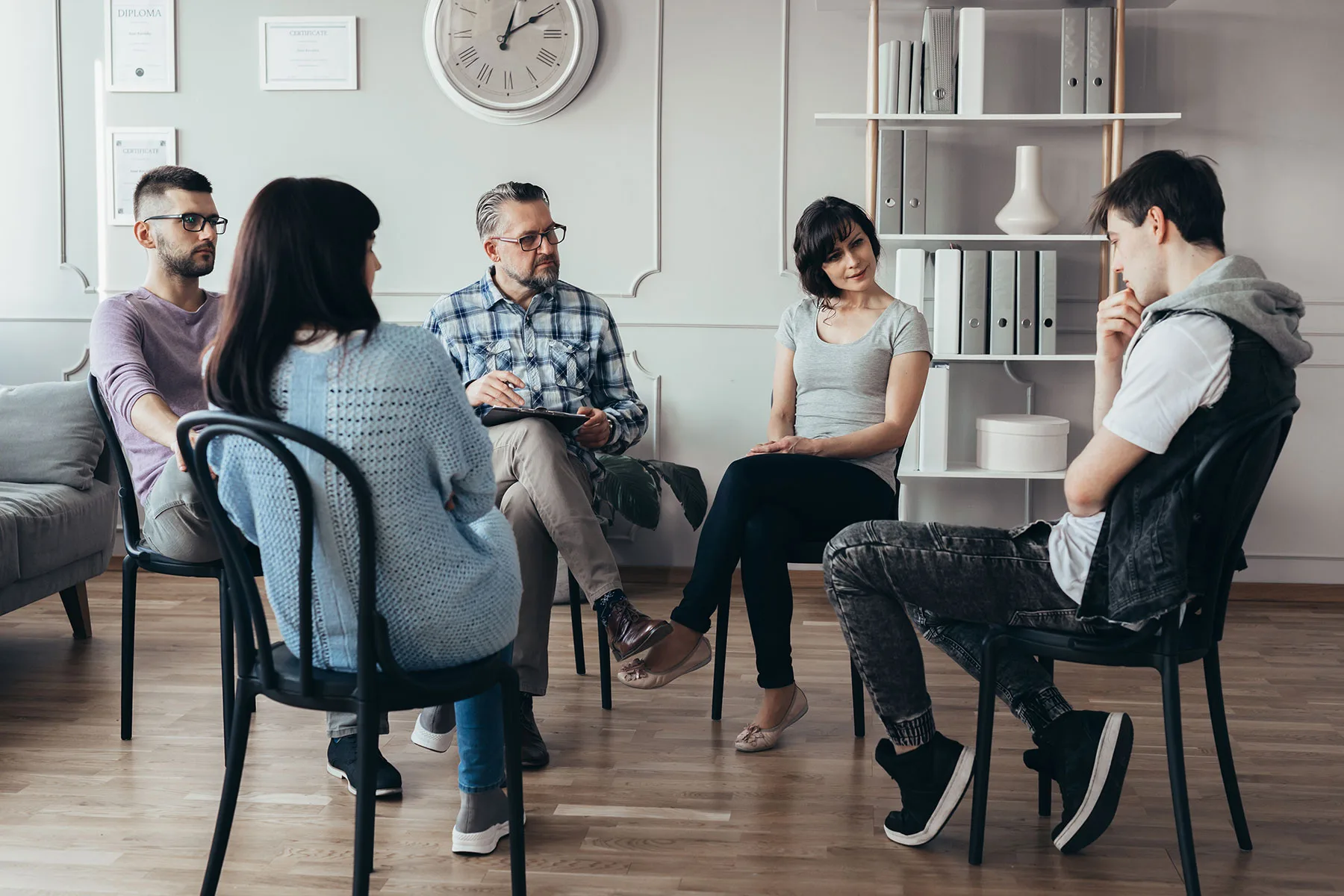 Support group seated in a circle in conversation