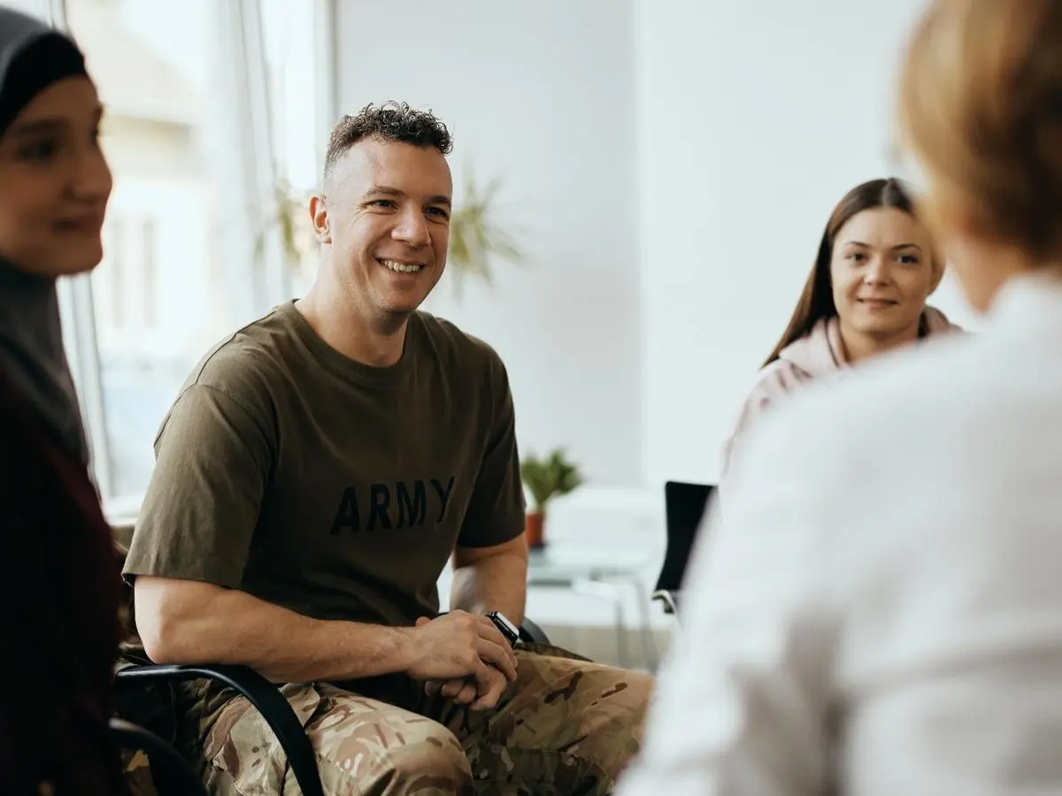 Soldier smiling during a group therapy session