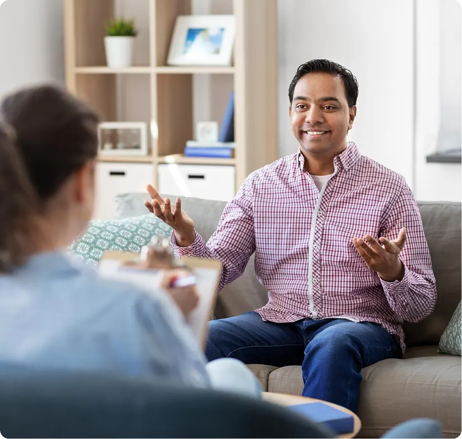 Man gesturing while speaking in a group therapy session