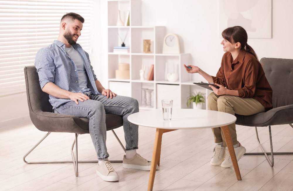 young man speaking to counselor